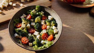 Broccoli in bowl with salad