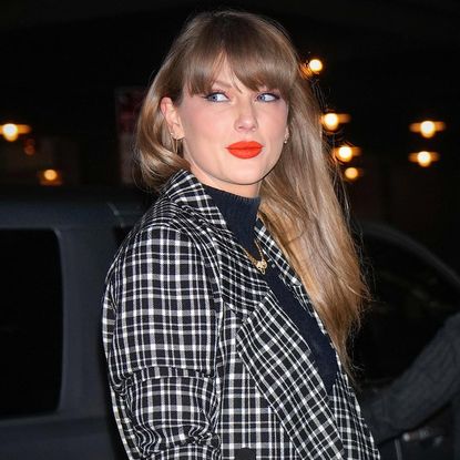 Taylor Swift wears a checked Carolina Herrera coat with a black turtleneck and a cartier necklace plus coral makeup in new york city