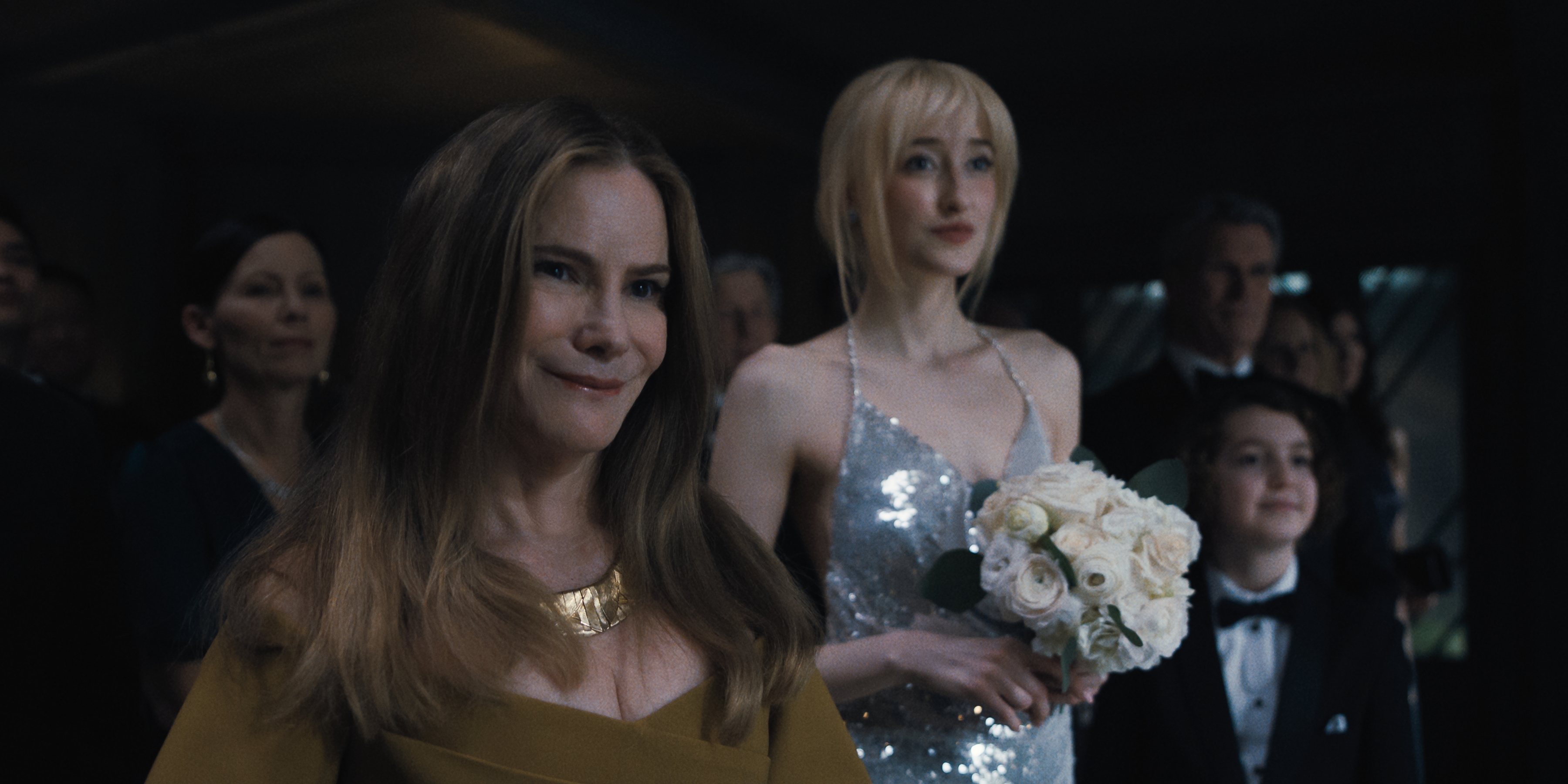 Jennifer Jason Leigh as Victoria, Gus Birney as Portia, Sawyer Fraser as Jude all wearing formal wear before a wedding in episode 108 of Something Very Bad Is Going To Happen