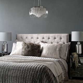 grey themed bedroom with chandelier