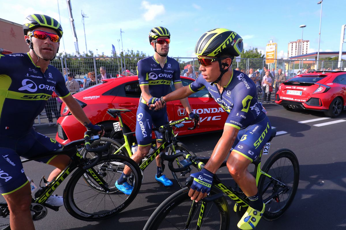 Caleb Ewan is consoled by his Orica-Scott teammates after the narrow loss