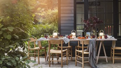 small garden ideas: covered deck area with table set for outdoor entertaining