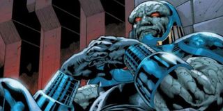 Darkseid sitting on his throne, hands folded in thought