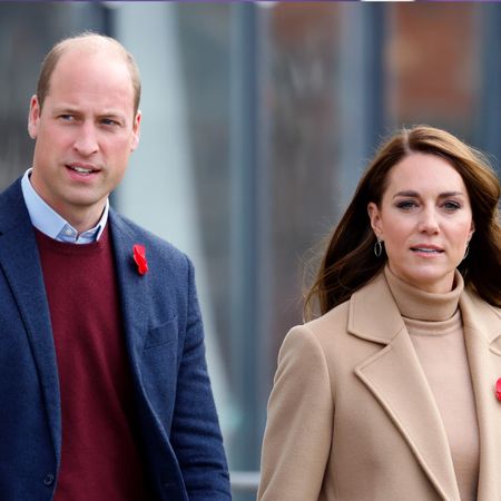 Prince William, wearing a red sweater and blue suit jacket, and Kate Middleton, wearing a camel coat and matching turtleneck sweater, visit Scarborough on November 3, 2022