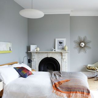 bedroom with grey wall and fire place