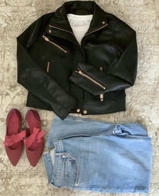 A leather jacket, red shoes, and light blue jeans.