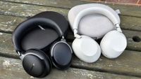 Bose QuietComfort Ultra Headphones next to Sony WH-1000XM6 headphones resting on their cases