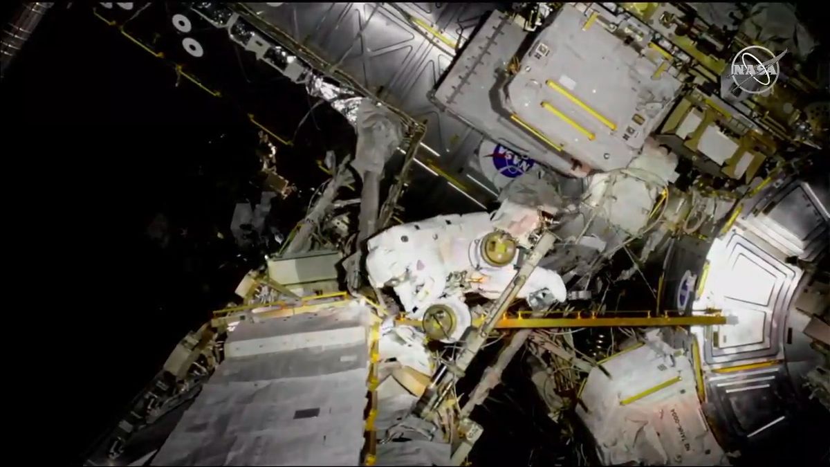 NASA astronaut Nick Hague heads over to assist McClain after her tether gets caught on something.