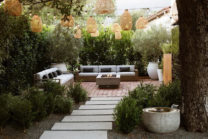 String lights light an outdoor pathway from above