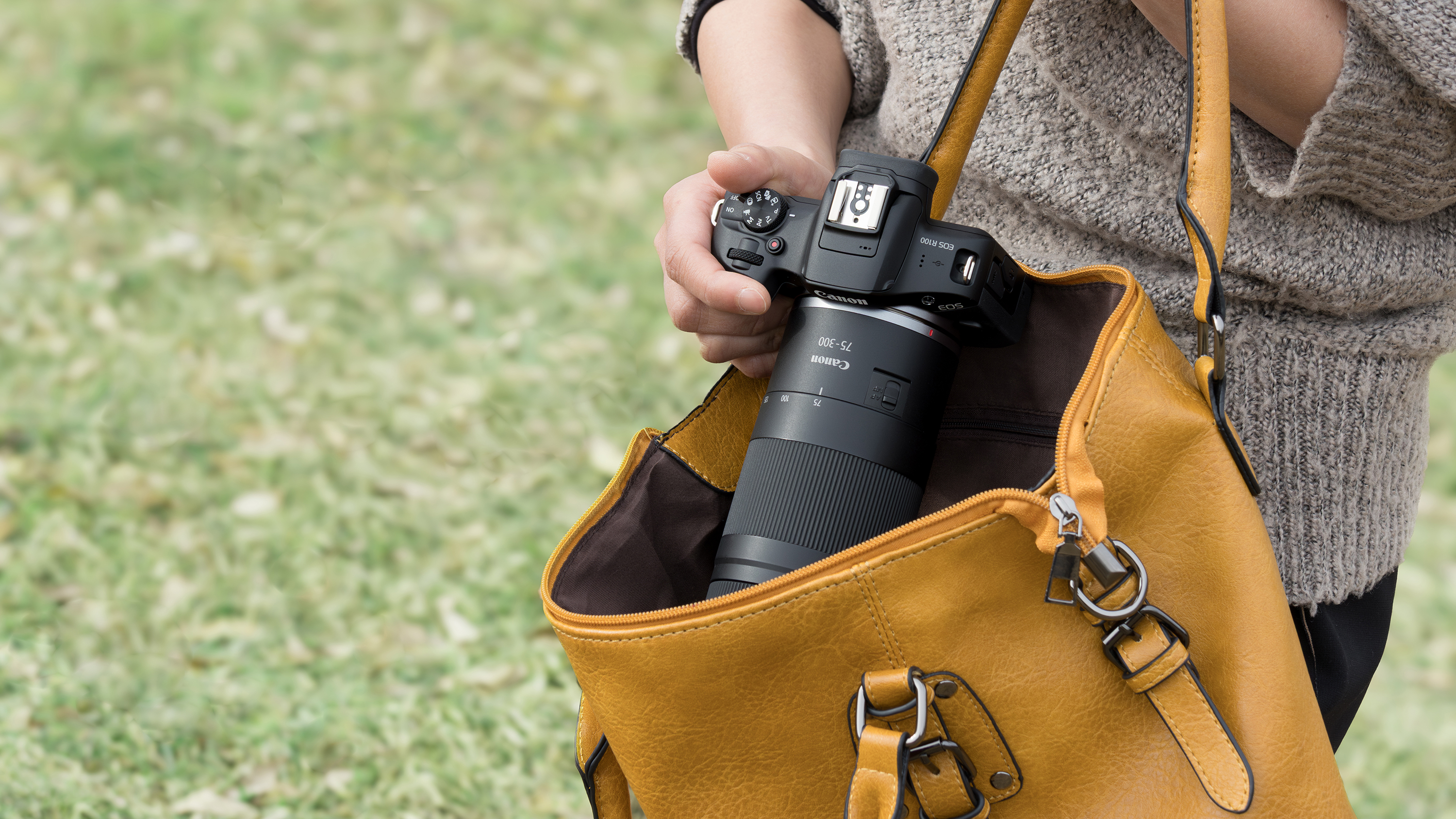 The Canon RF 75-300mm f/4-5.6 in a photographer's hands