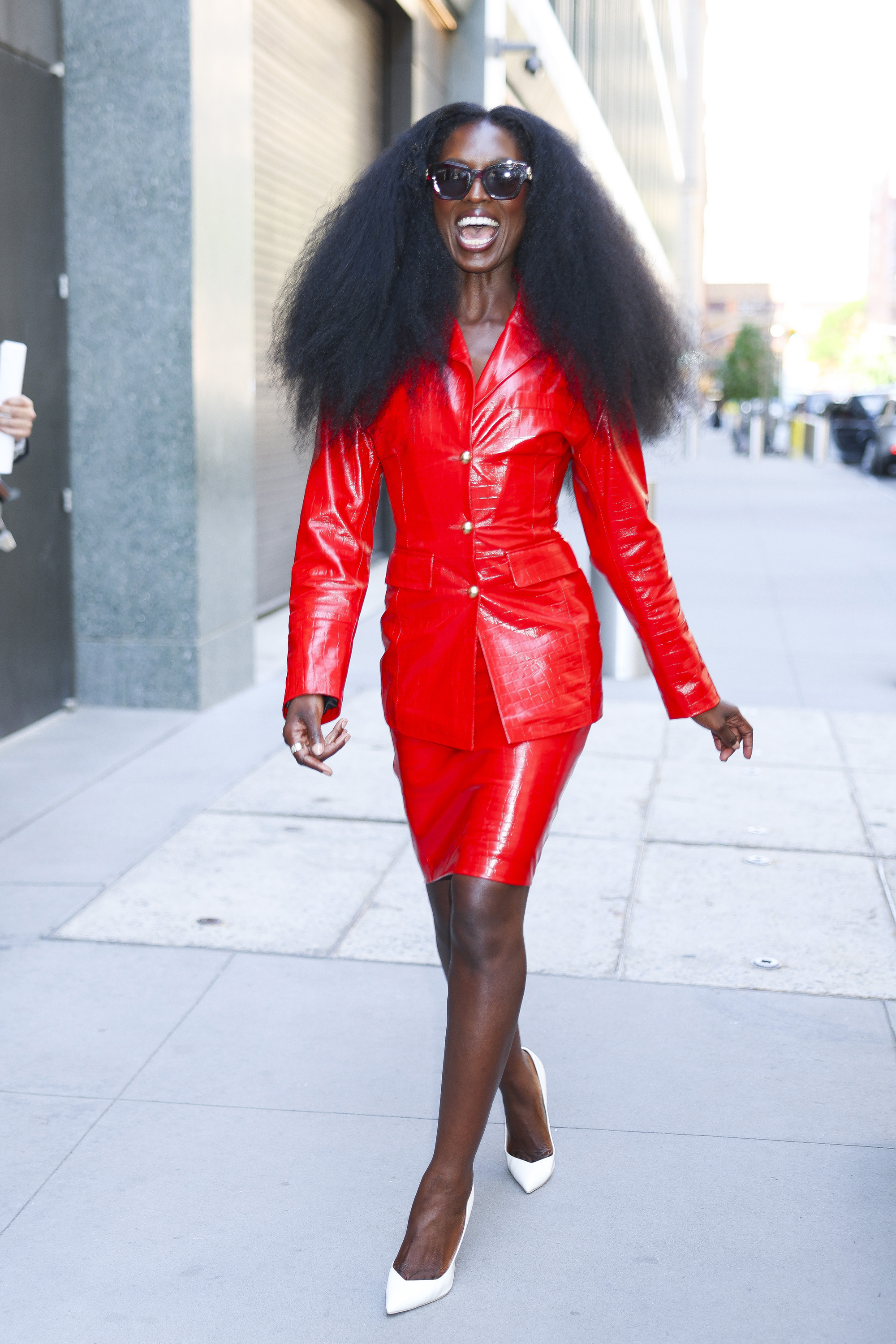 Jodie Turner Smith wearing a red leather skirt suit.