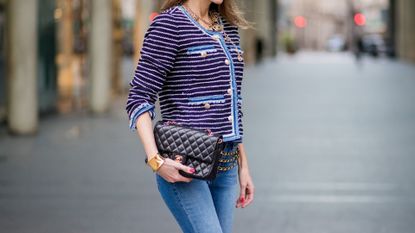 woman wearing chanel jacket and jeans street style