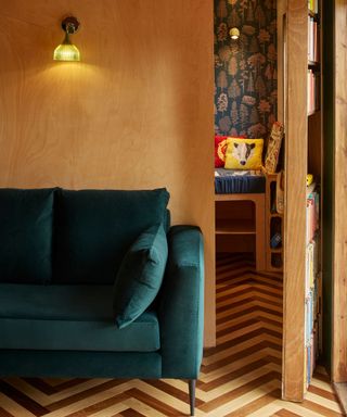 Hidden door with a bookcase leading from a sitting area to a playroom