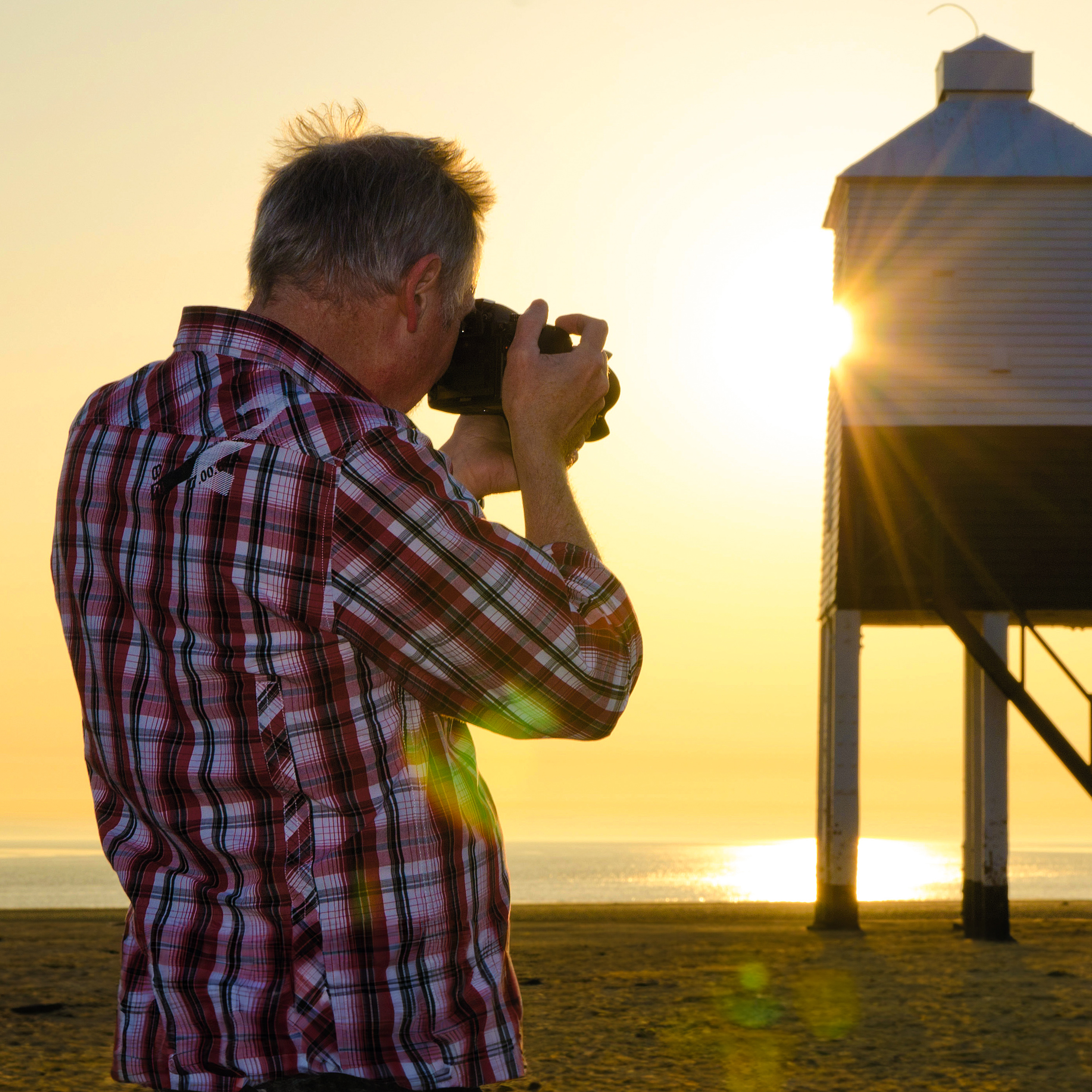 Rod Lawton photographing lighthouse at sunset