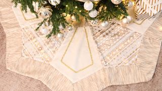 A gold and cream octagon shaped tree skirt