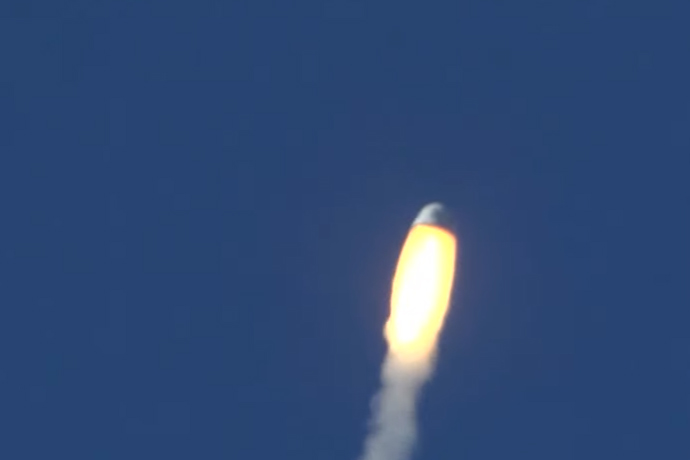 Blue Origin&#039;s New Shepard crew capsule streaks away from its booster during an unmanned in-flight abort test over West Texas on Oct. 5, 2016.