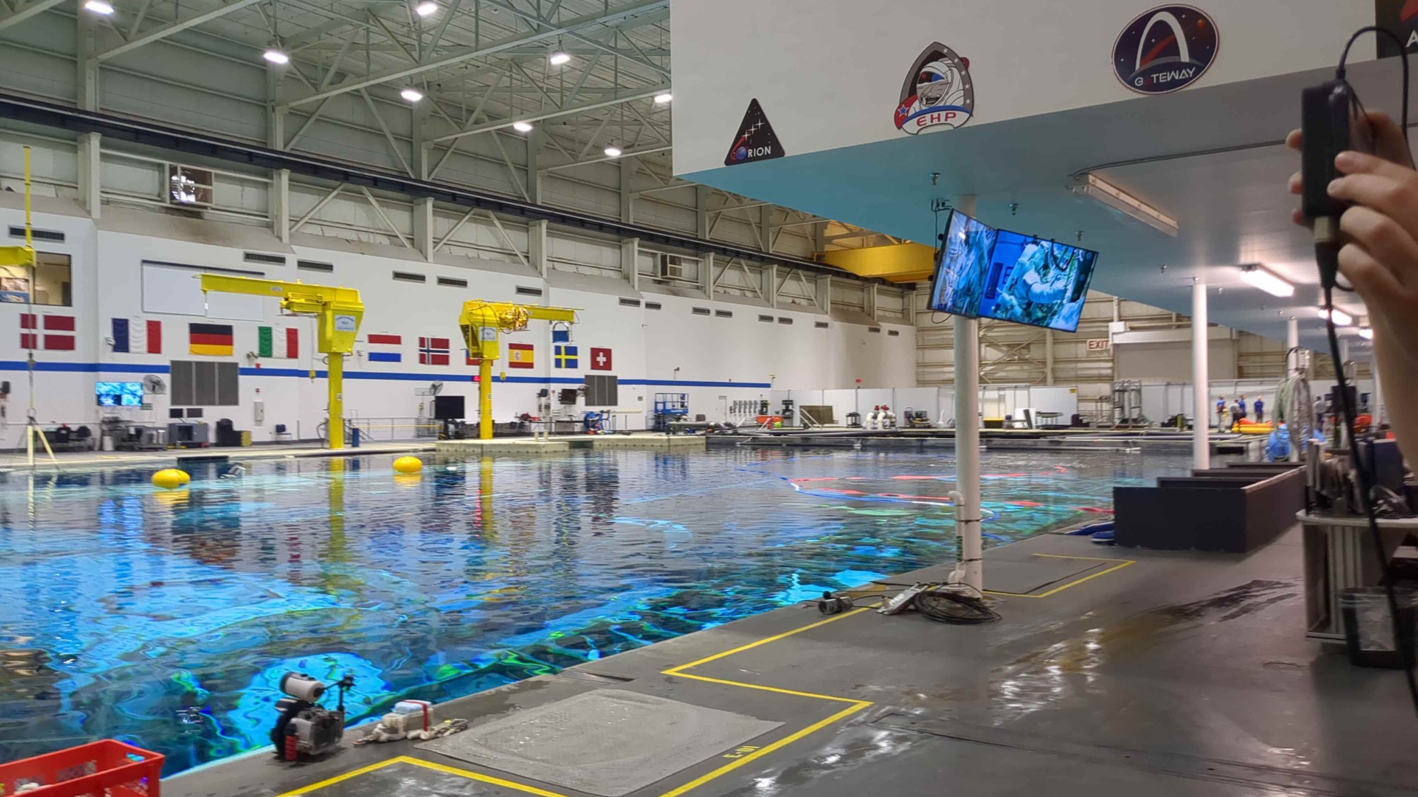 a large swimming pool inside a hangar-like building