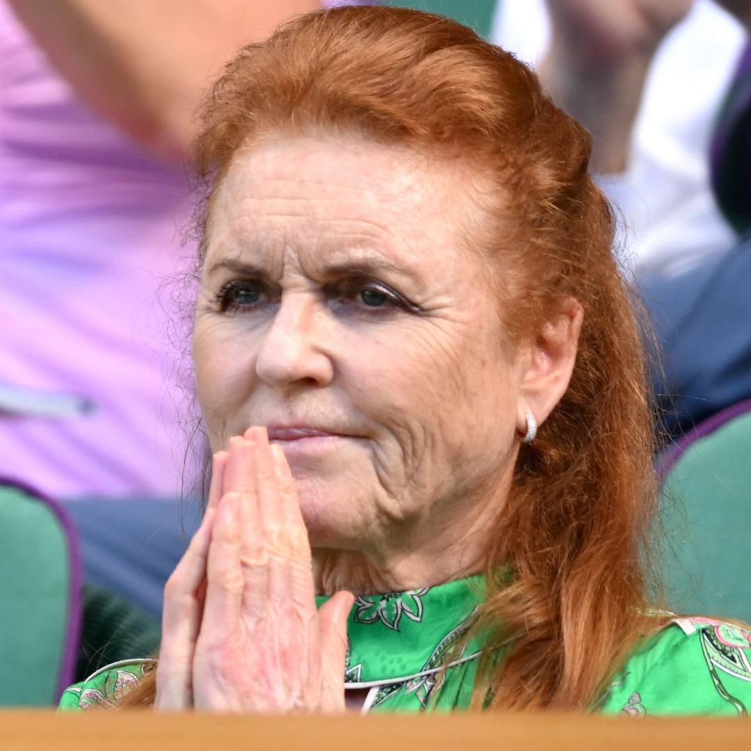 Sarah Ferguson wearing a green dress pressing her palms together