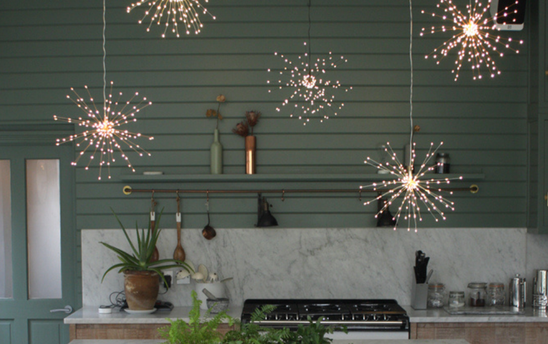 green panelled kitchen with snowflake fairy lights for Christmas 