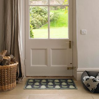 Front door with apple and pears doormat with dog bed and basket with wood