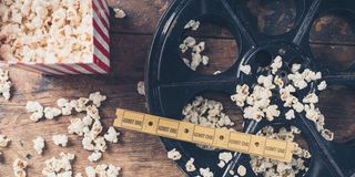 Popcorn spilled in movie theater photo from Shutterstock and Lolostock.