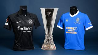 Eintracht Frankfurt and Glasgow Rangers football shirts either side of the UEFA Europa League trophy