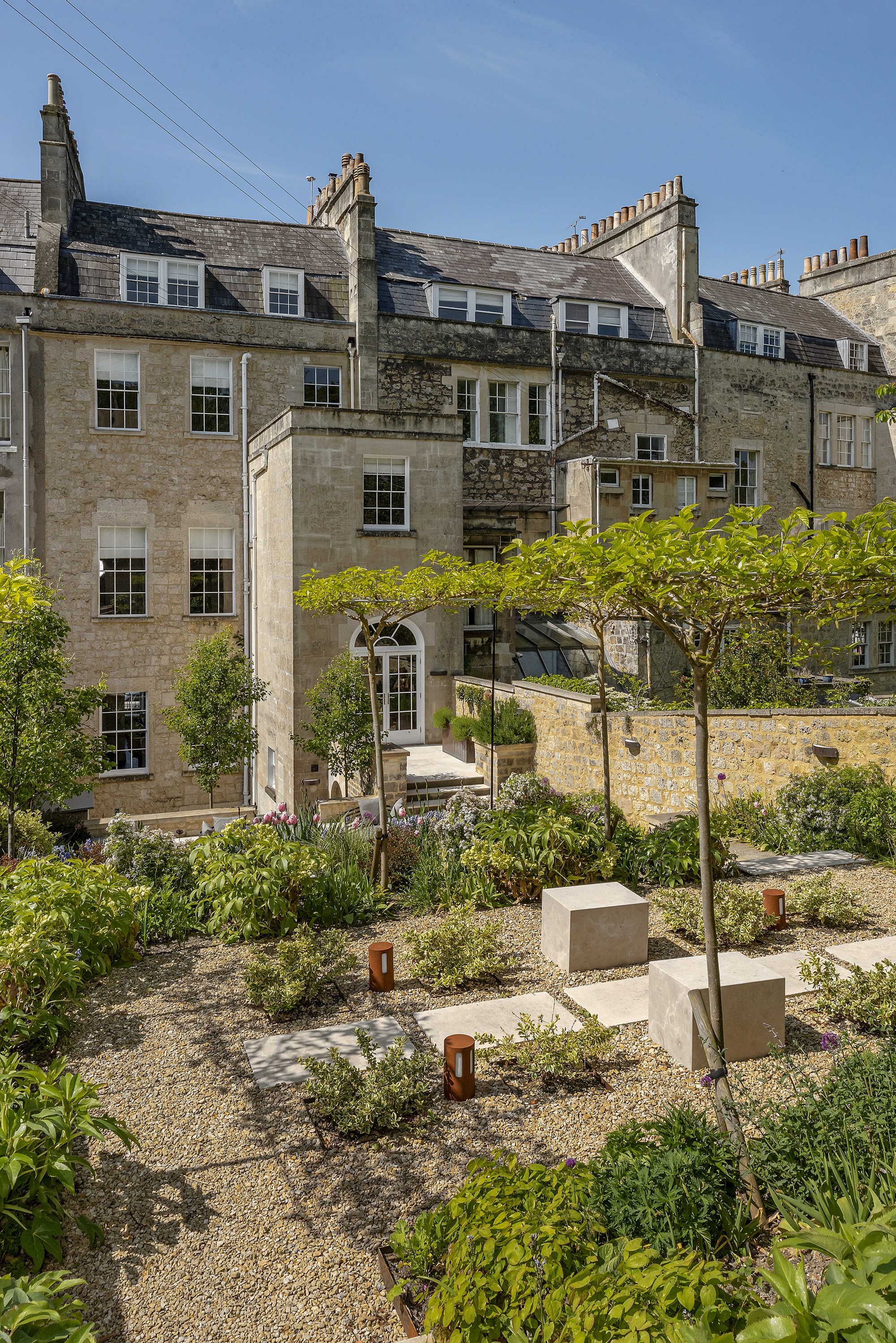 a garden on two levels with a canopy like tree in the middle