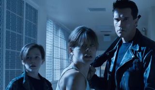 Terminator 2: Judgement Day John and Sarah Connor stand with a T-800 in the psych ward hallway