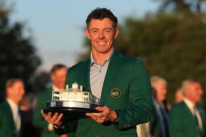 Rory McIlroy of Northern Ireland holds the Masters trophy after being awarded the Green Jacket