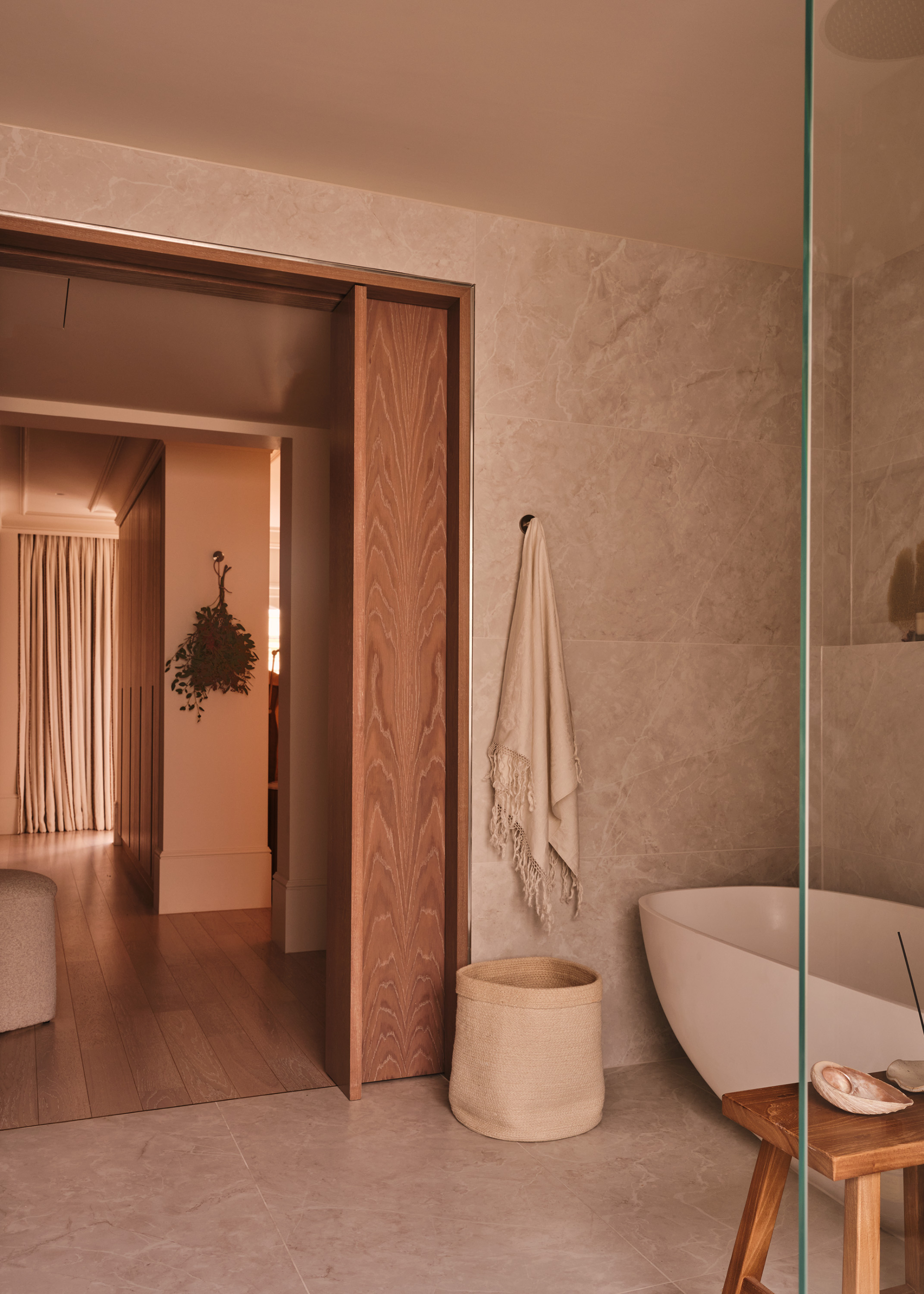 A modern minimalist bathroom with a relaxed holiday feel, natural materials and soft hazy lighting