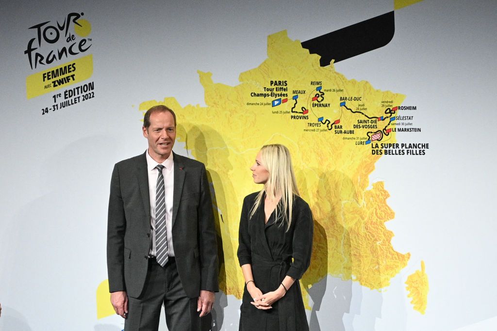 Tour de France director Christian Prudhomme and French cyclist Marion Rousse pose next to the map displaying the route of the womens Tour de France first edition during the official presentation of the cycling race in Paris on October 14 2021 Photo by AnneChristine POUJOULAT AFP Photo by ANNECHRISTINE POUJOULATAFP via Getty Images