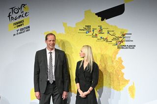 Tour de France director Christian Prudhomme and Tour de France Femmes director Marion Rousse pose next to the map displaying the route of the women's 2002 event during the official presentation in Paris