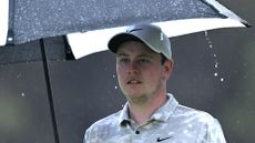 Robert Macintyre of Scotland under an umbrella during Day One of the Estrella Damm N.A. Andalucía Masters 