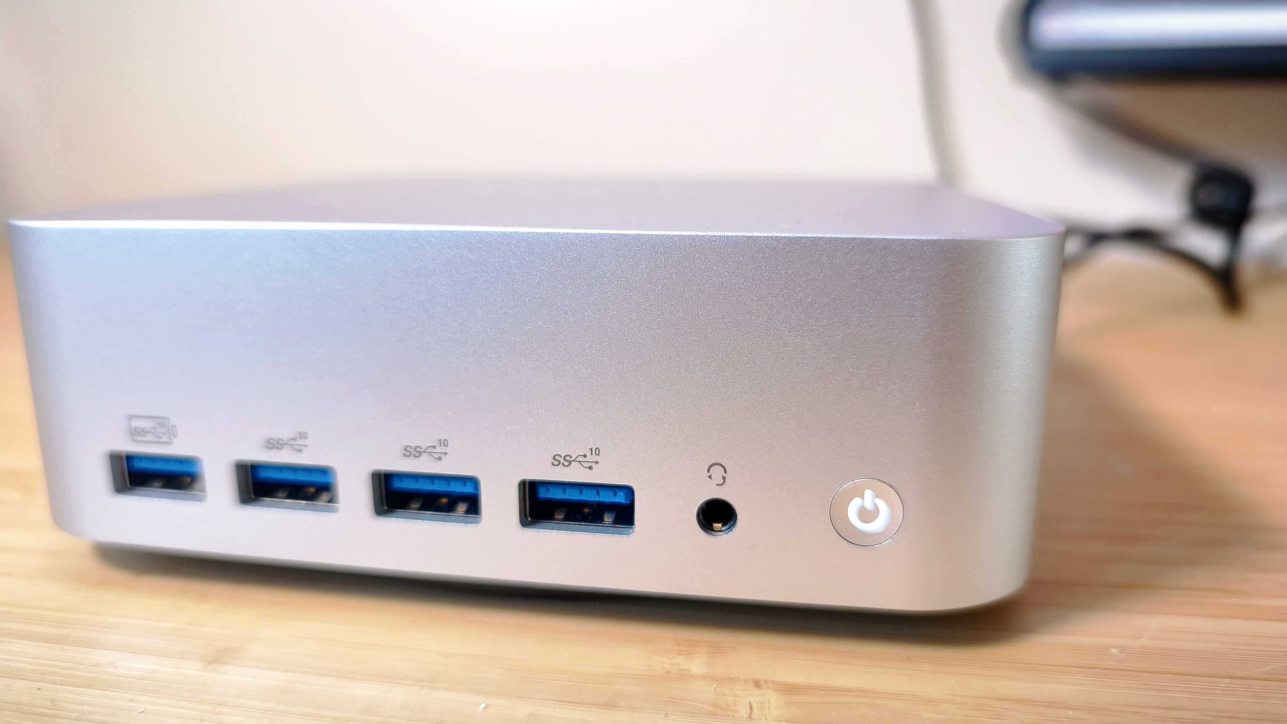 A silver Geekom A9 Max on a wooden desk