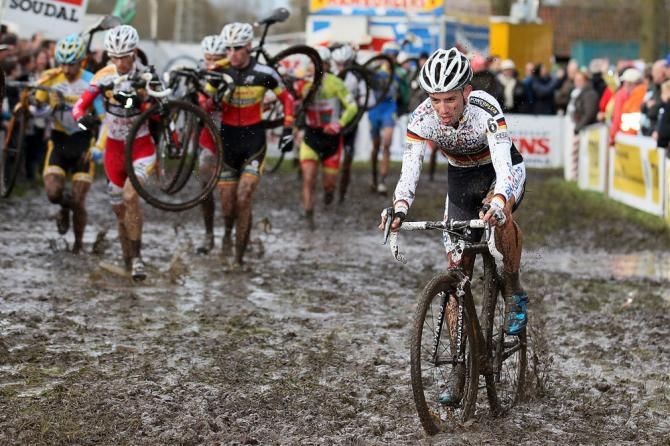 Philipp Walsleben (BKCP-Powerplus) rides while others opt to run in a muddy sector