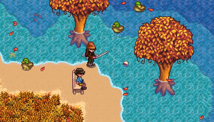 Stardew Valley - One player sits in a crafted chair in the sand while another player fishes in the water nearby.