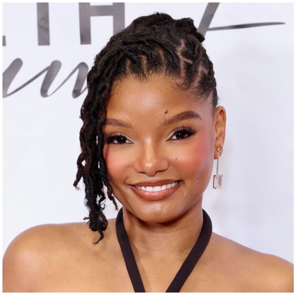 a black woman with locs styled in a bun with a side bang