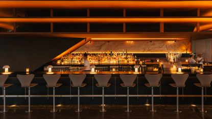 rooftop bar interior with warm wood and Fritz Hansen furniture 