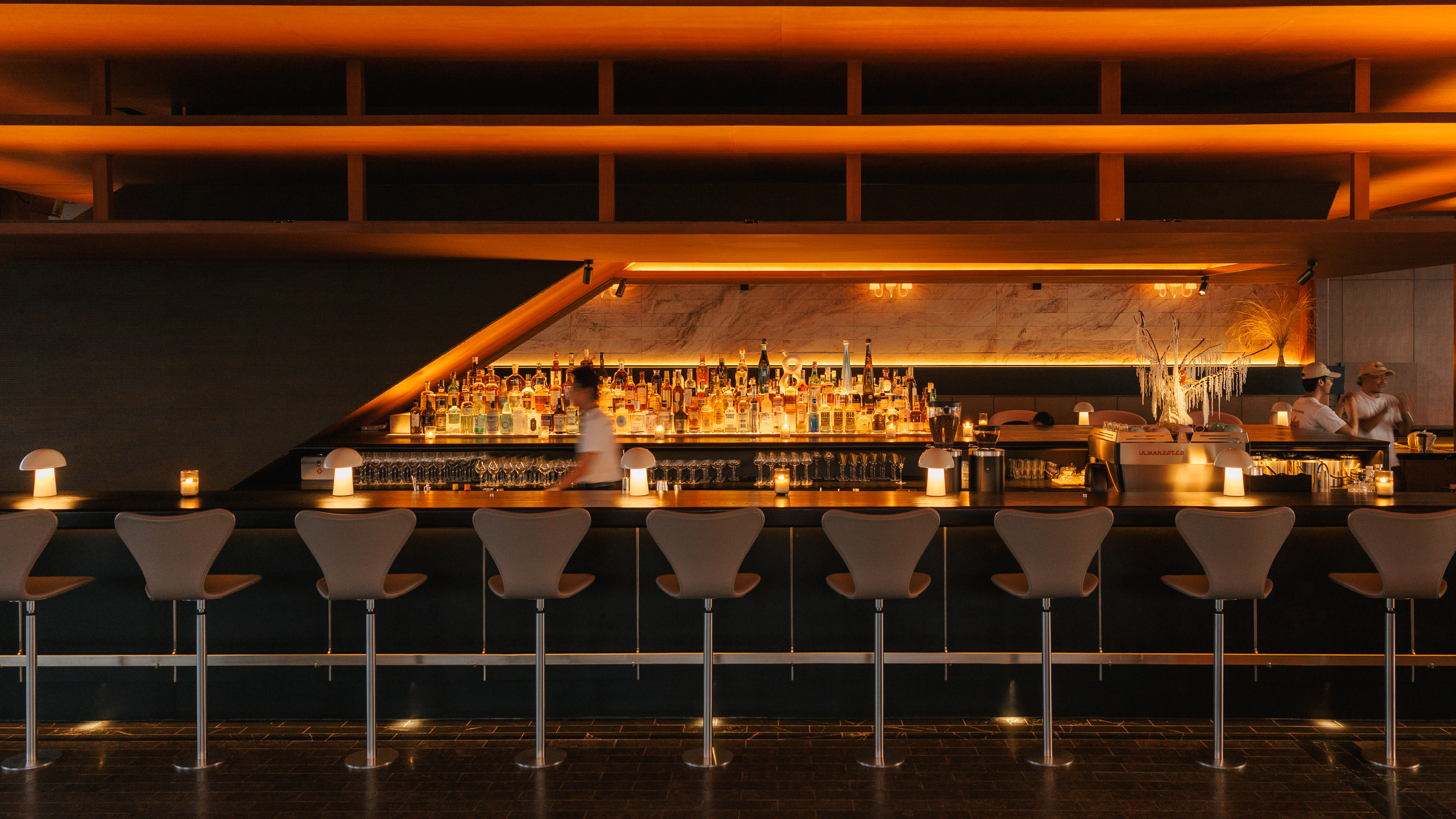 rooftop bar interior with warm wood and Fritz Hansen furniture 