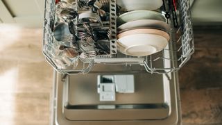 birds eye view of dishwasher with plates and cutlery inside