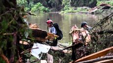 Members of a search and rescue team look for people near Camp Mystic, the site where at least 20 girls went missing after flash flooding in Hunt, Texas