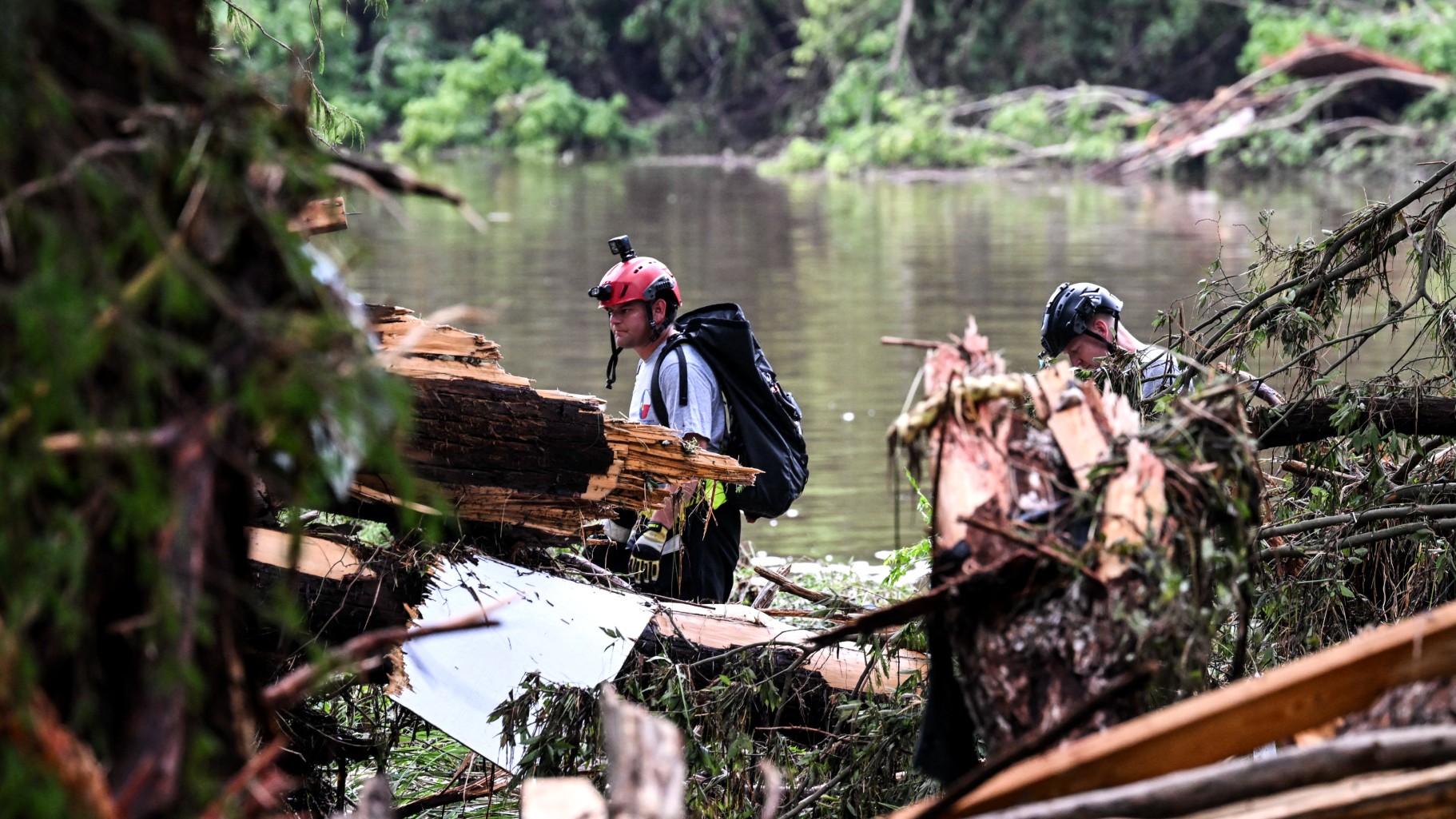 Members of a search and rescue team look for people near Camp Mystic, the site where at least 20 girls went missing after flash flooding in Hunt, Texas