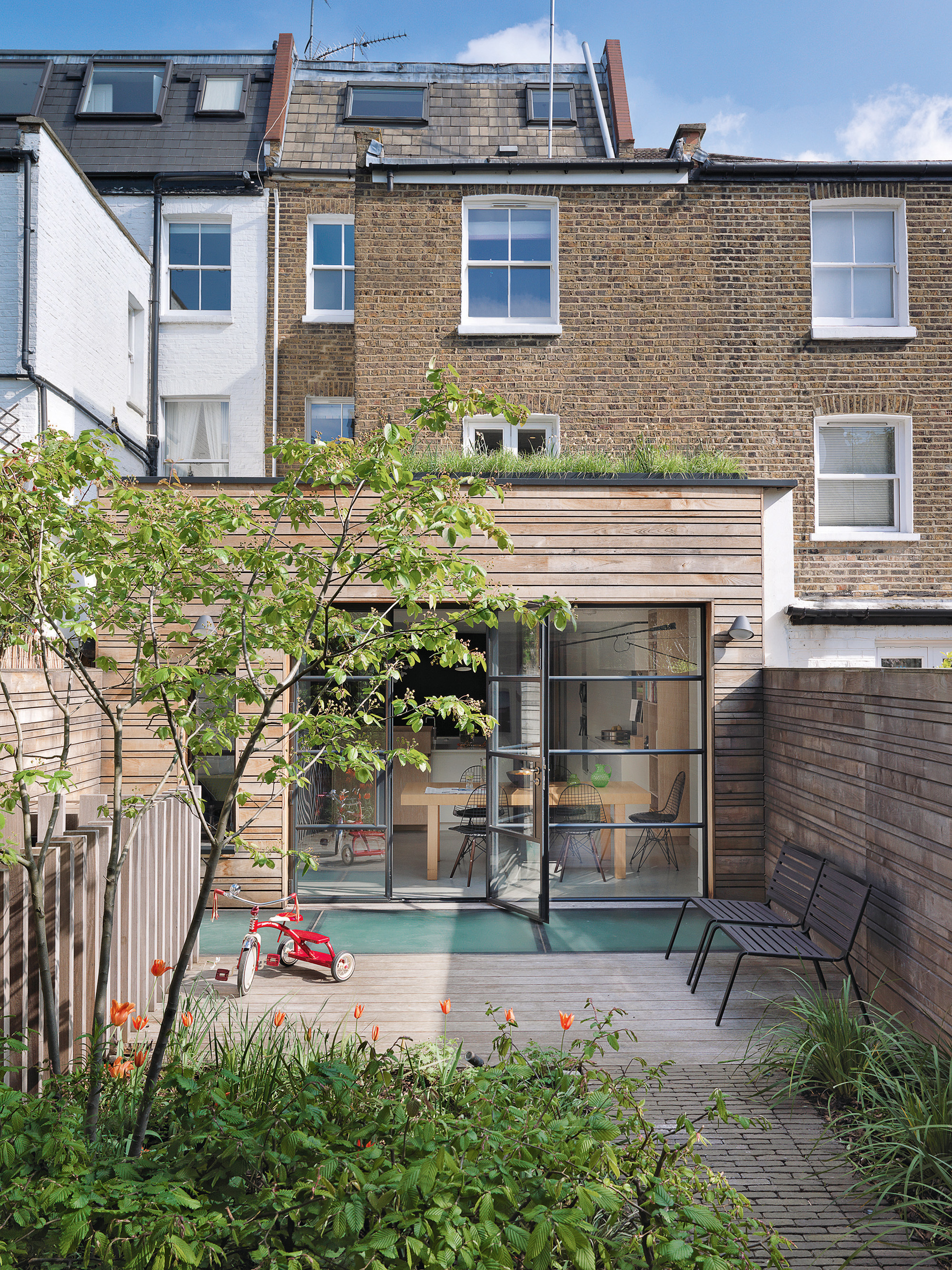 urban garden with paved patio and brick pathway