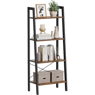 A wooden and steel ladder shelf with neutral-colored boxes, books, plants, pictures and ornaments