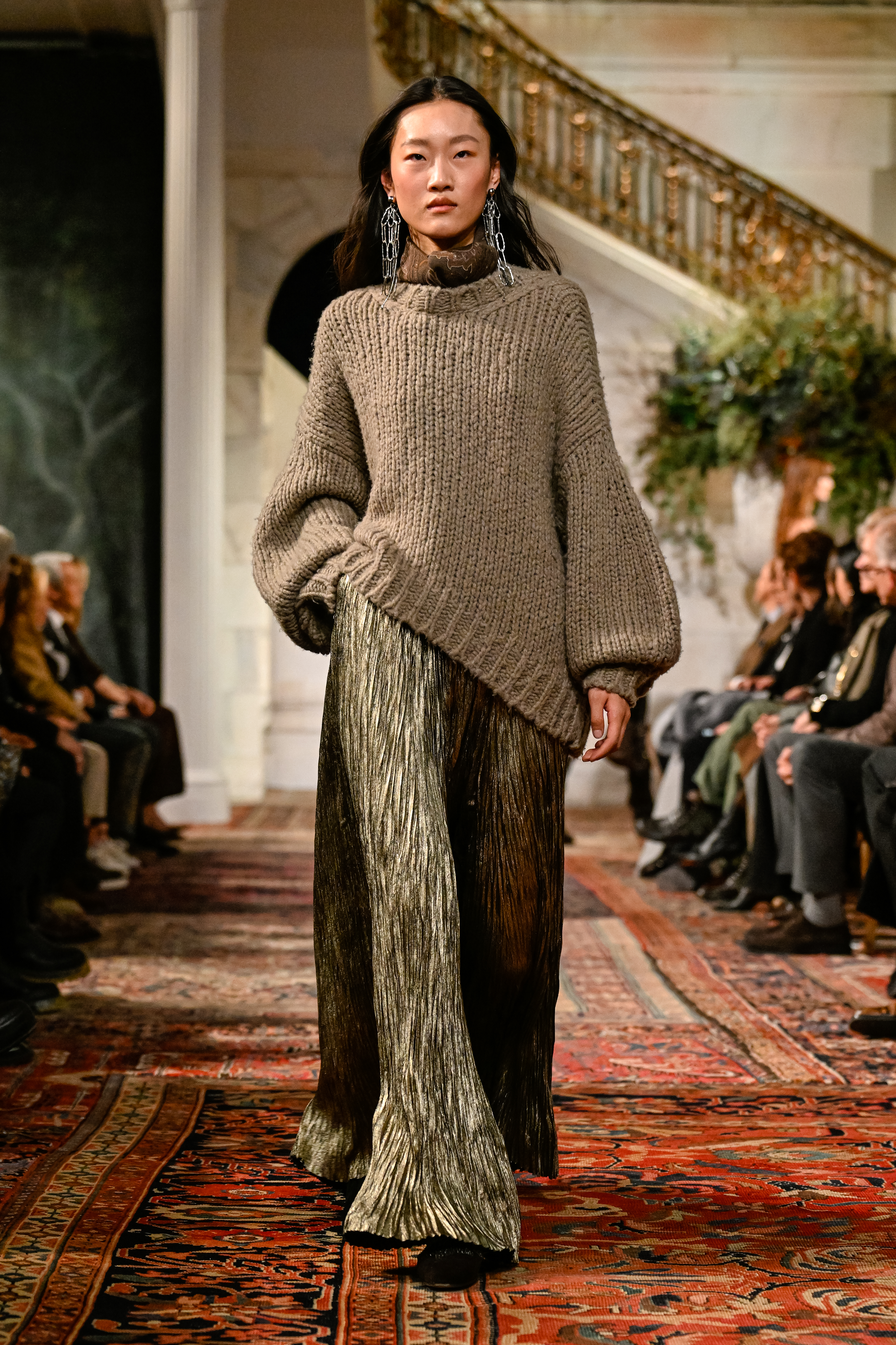 a model on the ralph lauren fall 2026 fashion show runway wearing a sweater and skirt