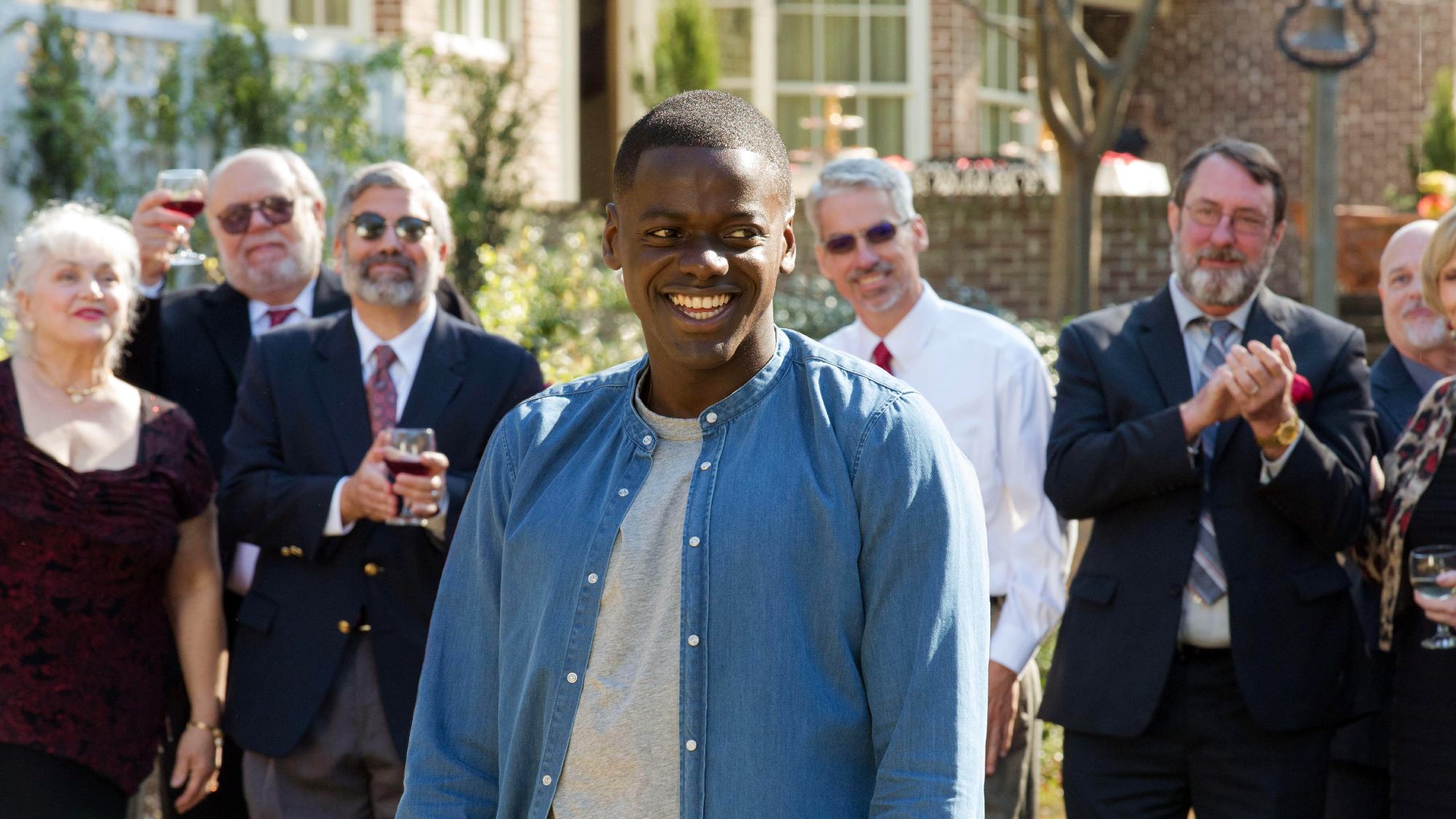 Daniel Kaluuya stands in front of a crowd in Get Out