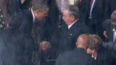 US President Barack Obama shakes hands with Cuban President Raul Castro in South Africa in 2013