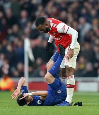 Arsenal’s Alexandre Lacazette, right, reacts to a challenge from Chelsea’s Jorginho