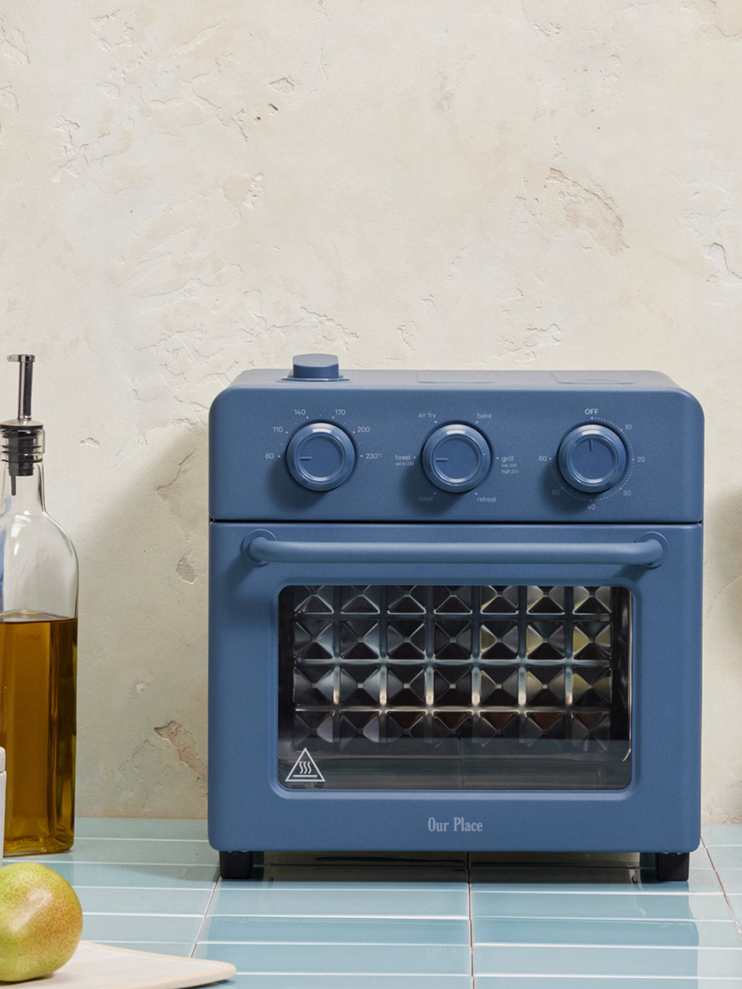 A bright blue countertop Wonder Oven from Our Place