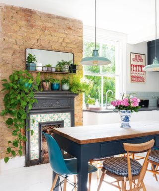 kitchen room with brick wall and dining table with chairs
